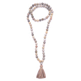 knotted fossilized coral with diamond ball & tassel