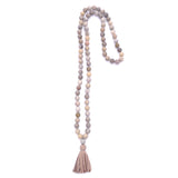 knotted fossilized coral with diamond ball & tassel